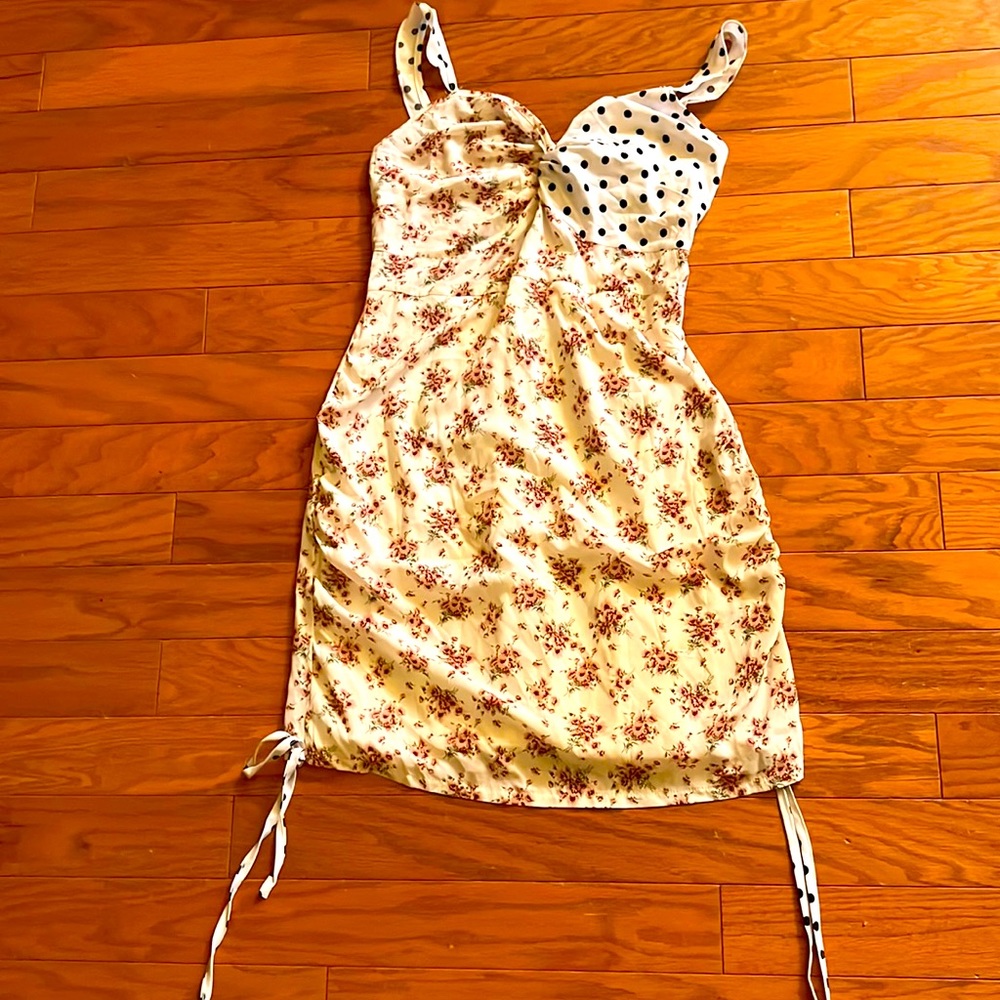 A women’s dress with a flower pattern and polkadots